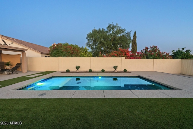 view of swimming pool with a lawn, a patio, a fenced in pool, and fence