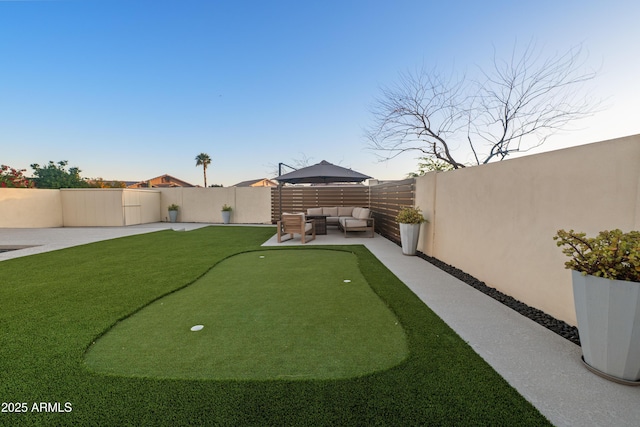 view of yard featuring outdoor lounge area, a fenced backyard, and a patio area
