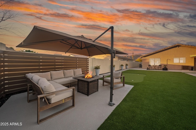 view of patio with an outdoor living space with a fire pit and a fenced backyard