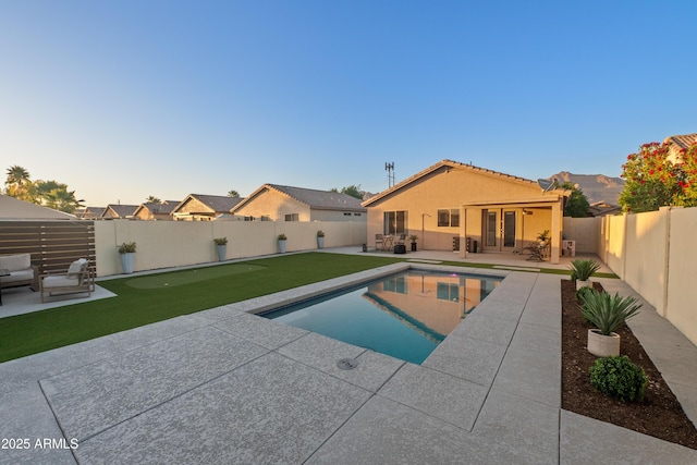 view of swimming pool featuring french doors, a fenced backyard, an outdoor hangout area, and a patio area