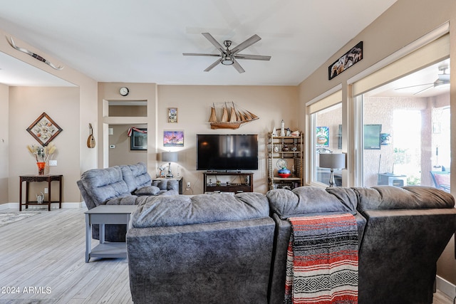 living room with ceiling fan and light hardwood / wood-style flooring