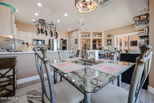 dining room with light hardwood / wood-style flooring and ceiling fan