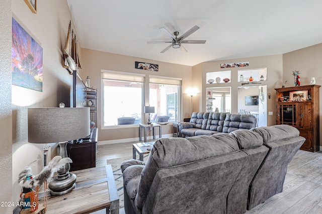 living room with ceiling fan and light hardwood / wood-style floors