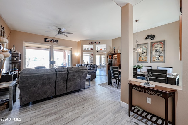 living room with ceiling fan and light hardwood / wood-style floors