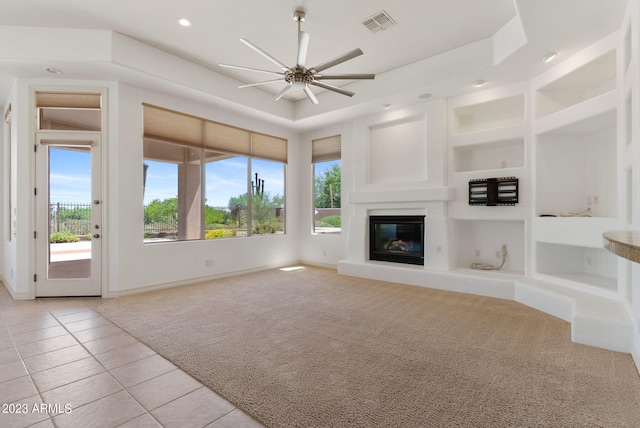 22463 N 54th St, Phoenix, AZ 85054 - unfurnished living room with healthy amount of natural light, a ceiling fan, light carpet, a glass covered fireplace, and recessed lighting