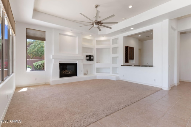 22463 N 54th St, Phoenix, AZ 85054 - unfurnished living room featuring baseboards, light colored carpet, light tile patterned floors, a glass covered fireplace, and ceiling fan