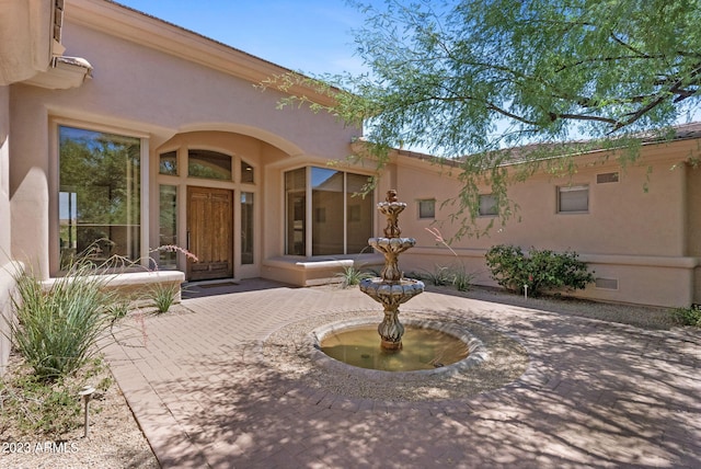 22463 N 54th St, Phoenix, AZ 85054 - view of exterior entry with a patio area and stucco siding