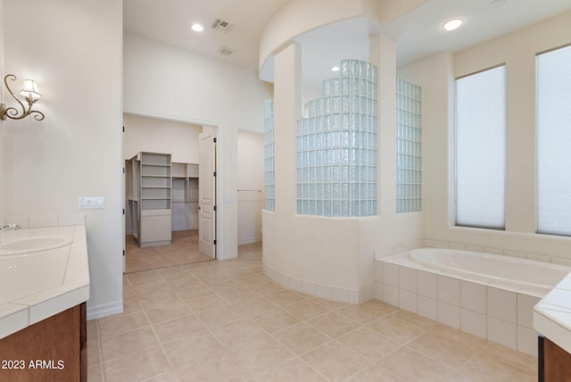22463 N 54th St, Phoenix, AZ 85054 - bathroom featuring tile patterned floors, a garden tub, vanity, a walk in closet, and recessed lighting