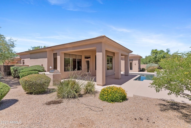 22463 N 54th St, Phoenix, AZ 85054 - rear view of property with stucco siding, a patio, and an outdoor pool