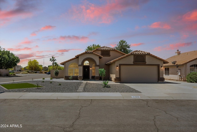 mediterranean / spanish home with a garage