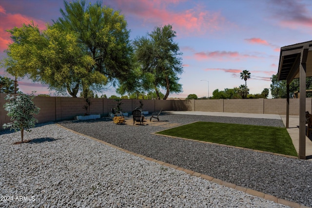 yard at dusk with a patio area