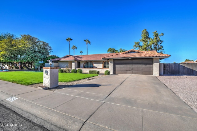 view of front of property featuring a front yard and a garage