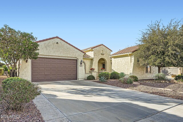 mediterranean / spanish house with a garage