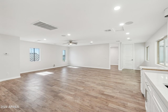 unfurnished living room featuring light hardwood / wood-style floors and ceiling fan