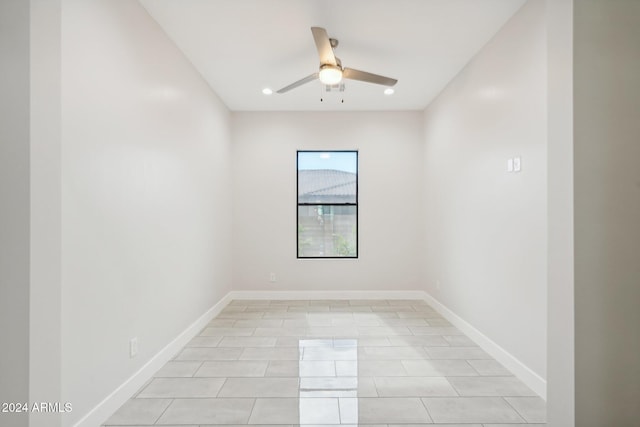 tiled empty room with ceiling fan