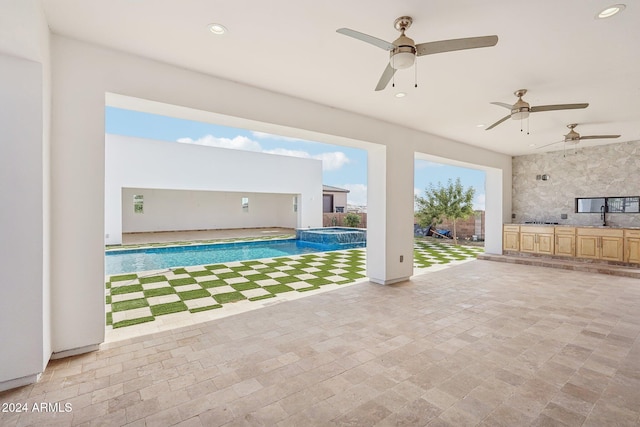 view of swimming pool with ceiling fan and sink