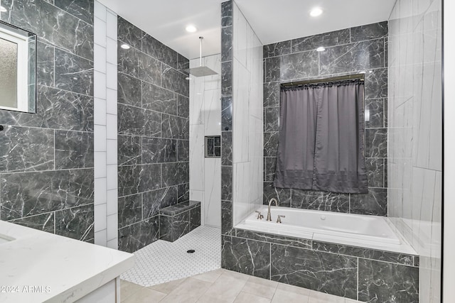 bathroom with tile walls, tile patterned flooring, and shower with separate bathtub