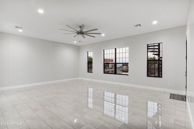 unfurnished room featuring ceiling fan and light tile patterned floors