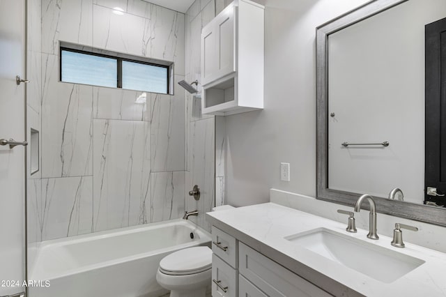 full bathroom featuring tiled shower / bath, toilet, and vanity