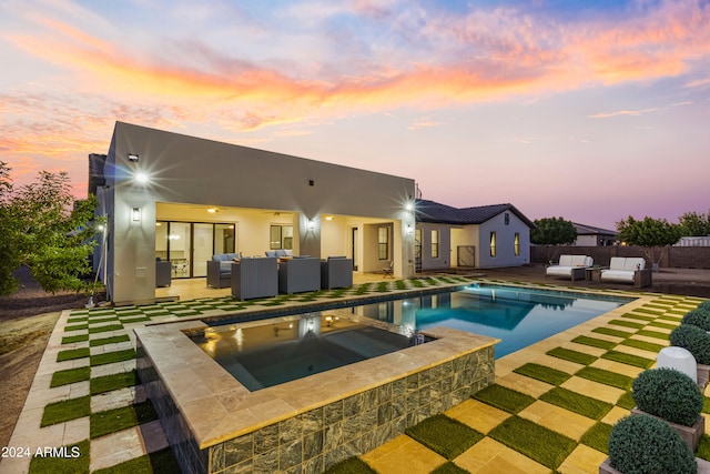 pool at dusk with an outdoor living space, french doors, a patio, and an in ground hot tub