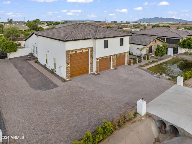 view of home's exterior with a garage and a mountain view