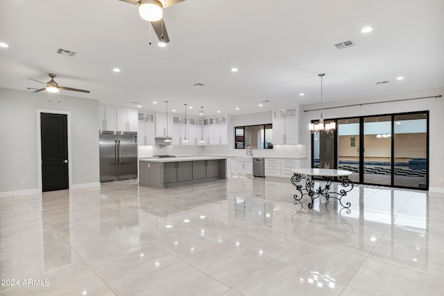 kitchen featuring white cabinetry, a spacious island, appliances with stainless steel finishes, and decorative light fixtures