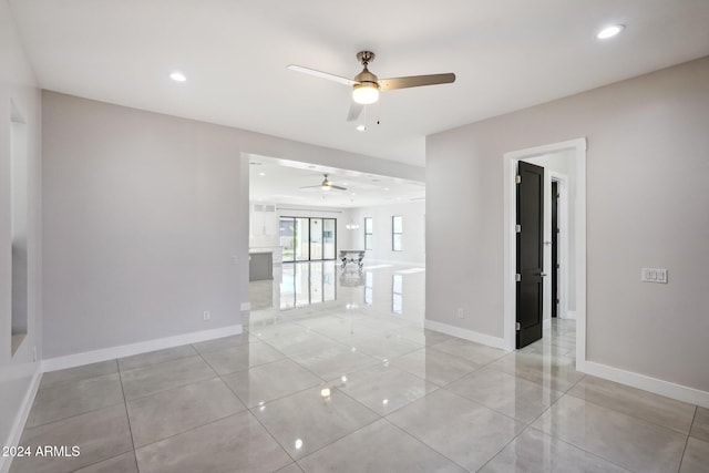 empty room with light tile patterned flooring and ceiling fan