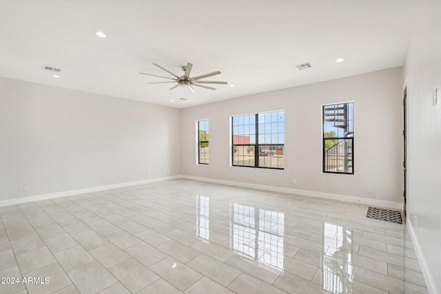 spare room featuring ceiling fan and light tile patterned floors