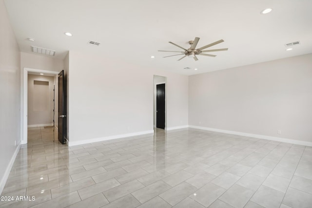 spare room featuring light tile patterned flooring and ceiling fan