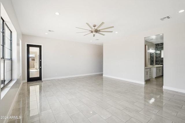 spare room featuring a wealth of natural light and ceiling fan