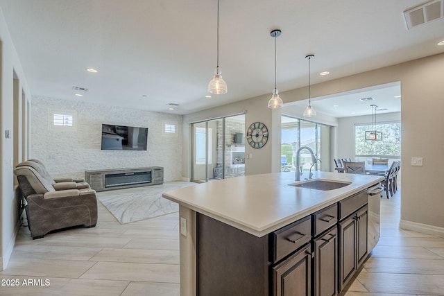 841 E Farmers Ln, Queen Creek, AZ 85140 - kitchen with a sink, baseboards, open floor plan, recessed lighting, and dark brown cabinets