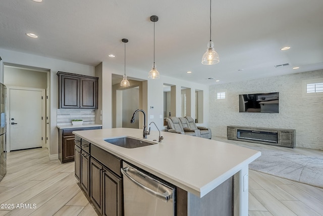 841 E Farmers Ln, Queen Creek, AZ 85140 - kitchen with a sink, stainless steel dishwasher, open floor plan, light countertops, and dark brown cabinetry