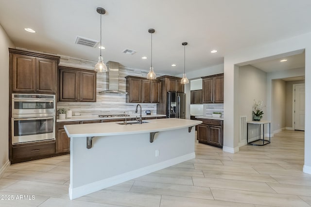 841 E Farmers Ln, Queen Creek, AZ 85140 - kitchen featuring wall chimney range hood, a sink, appliances with stainless steel finishes, backsplash, and light countertops