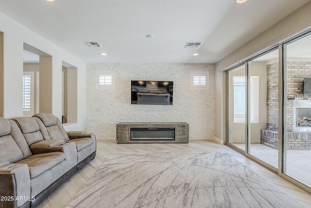 841 E Farmers Ln, Queen Creek, AZ 85140 - living room featuring a glass covered fireplace, healthy amount of natural light, wood finished floors, and recessed lighting