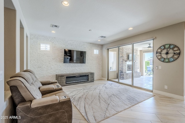 841 E Farmers Ln, Queen Creek, AZ 85140 - living room featuring baseboards, a glass covered fireplace, and recessed lighting