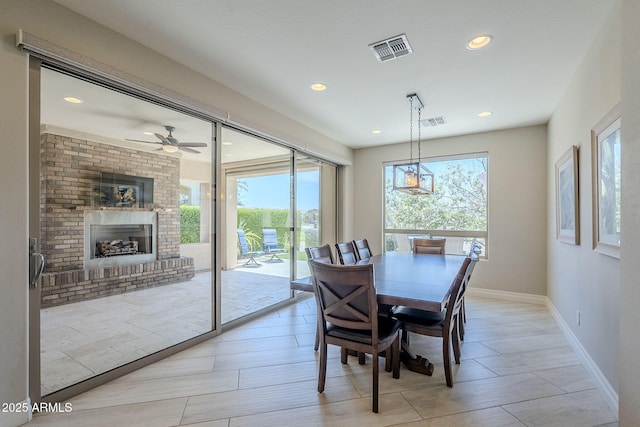 841 E Farmers Ln, Queen Creek, AZ 85140 - dining space with baseboards, a fireplace, recessed lighting, and a ceiling fan