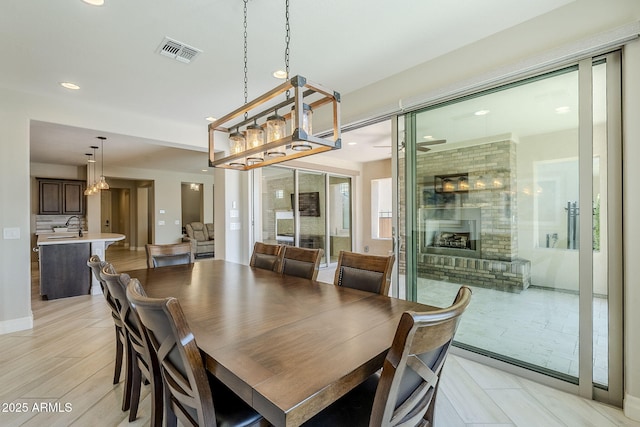 841 E Farmers Ln, Queen Creek, AZ 85140 - dining room with recessed lighting, a fireplace, and baseboards