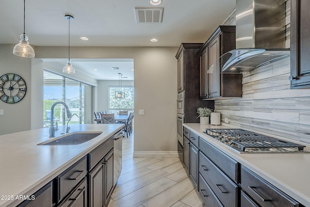 841 E Farmers Ln, Queen Creek, AZ 85140 - kitchen featuring a sink, wall chimney range hood, appliances with stainless steel finishes, light countertops, and backsplash