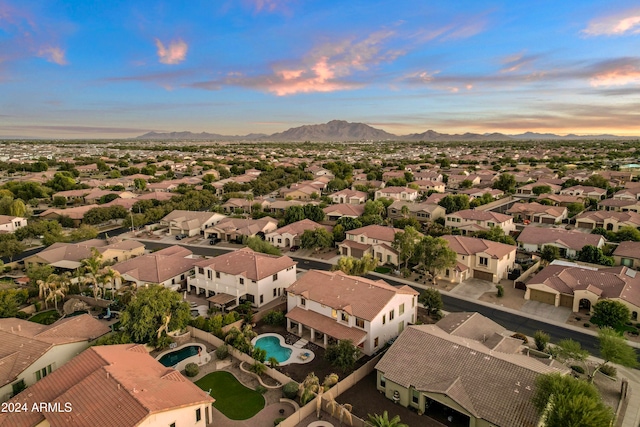 aerial view at dusk featuring a mountain view