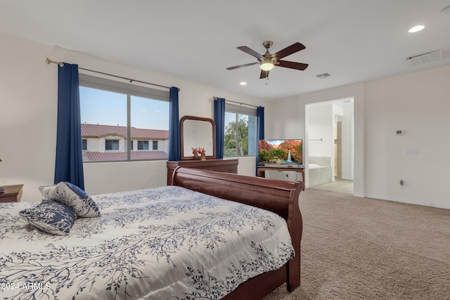 carpeted bedroom with ceiling fan and connected bathroom