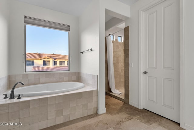 bathroom with separate shower and tub