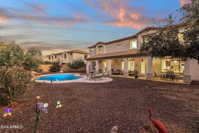 pool at dusk with a patio