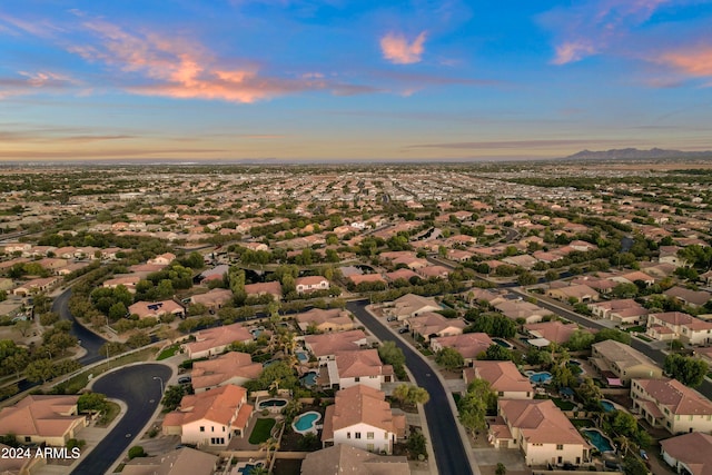 aerial view at dusk featuring a mountain view