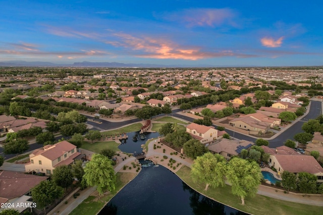 aerial view at dusk with a water view