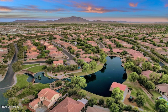 aerial view at dusk with a water and mountain view