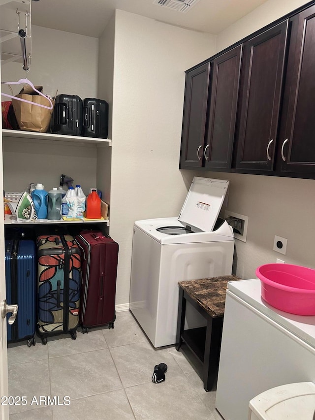 15301 W Moreland St, Goodyear, AZ 85338 - laundry room with cabinet space, light tile patterned floors, visible vents, and washer / clothes dryer