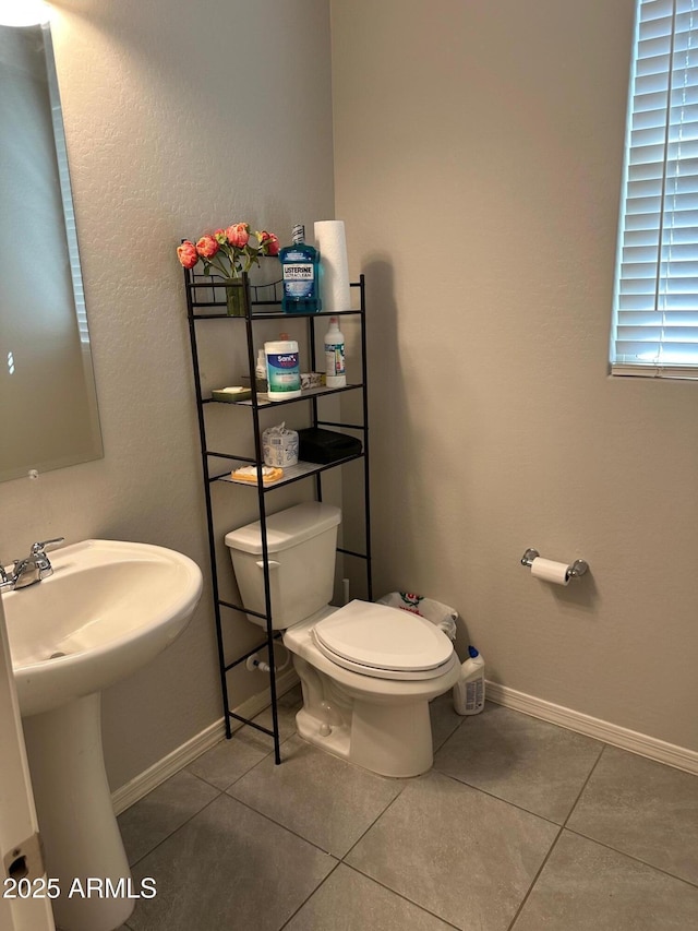 15301 W Moreland St, Goodyear, AZ 85338 - half bathroom with toilet, tile patterned flooring, a sink, and baseboards