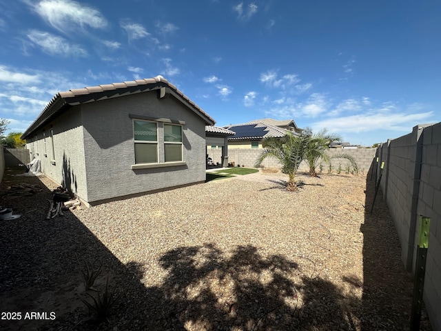 15301 W Moreland St, Goodyear, AZ 85338 - back of house featuring stucco siding, a tile roof, and a fenced backyard