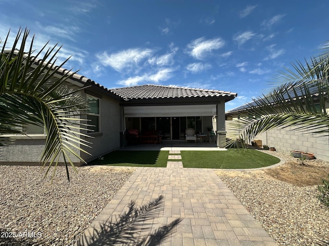 15301 W Moreland St, Goodyear, AZ 85338 - rear view of house featuring a tiled roof, a patio area, and stucco siding