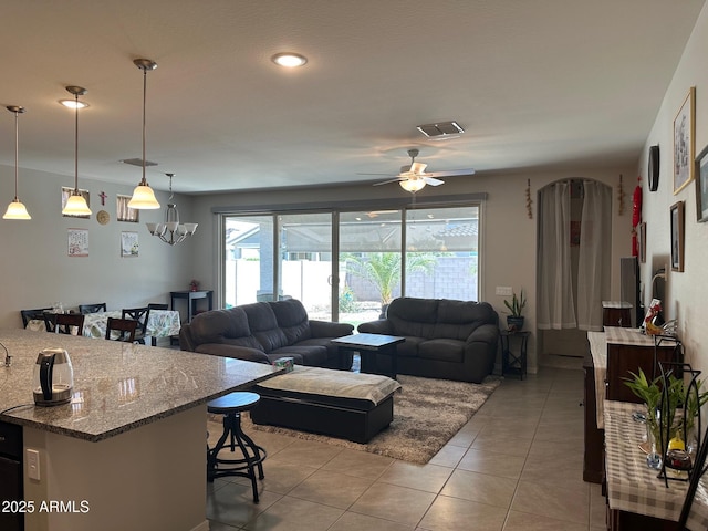 15301 W Moreland St, Goodyear, AZ 85338 - living room featuring light tile patterned floors, ceiling fan, and visible vents